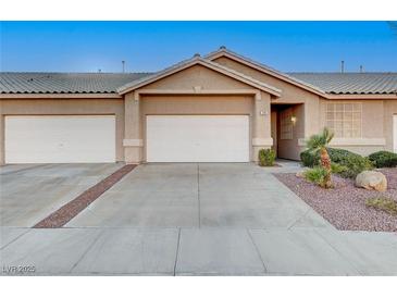 Charming single-story home with a two-car garage, landscaped yard, and desert rock at 209 Roxborough St, Henderson, NV 89074