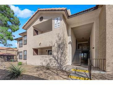 A two story condominium building featuring stairwell access and covered balconies at 2451 N Rainbow Blvd # 1006, Las Vegas, NV 89108