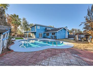 Backyard pool and brick patio perfect for outdoor enjoyment at 3675 Winner Dr, Las Vegas, NV 89120