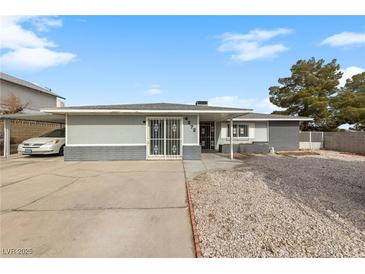 Single-story home featuring a large front yard, driveway, and a covered carport at 4272 E Russell Rd, Las Vegas, NV 89120