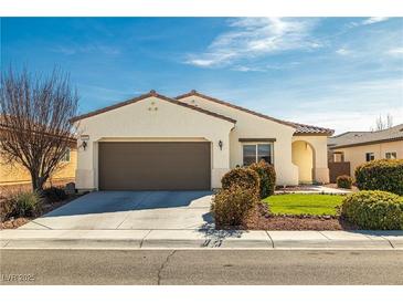 Charming single-story home featuring a two-car garage, stucco exterior, and a well-manicured front lawn at 5081 Monte Penne Way, Pahrump, NV 89061