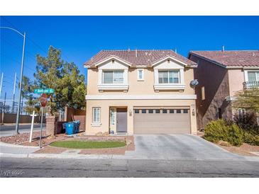 Two-story home featuring a terra cotta-colored roof, neutral-colored siding, and a two-car garage at 5186 Bootlegger Ave, Las Vegas, NV 89141