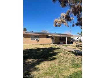 Charming single-story home with well-kept lawn and solar panels installed on the roof at 535 Straight St, Las Vegas, NV 89110