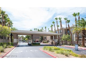 Welcoming gated community entrance featuring palm trees and well-maintained landscaping at 7123 S Durango Dr # 206, Las Vegas, NV 89113