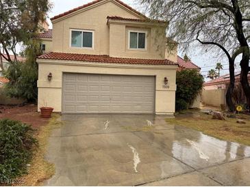 Charming two-story home featuring a red tile roof, neutral stucco, and a spacious two-car garage with a wide driveway at 7509 Wheat Grass Ct, Las Vegas, NV 89129