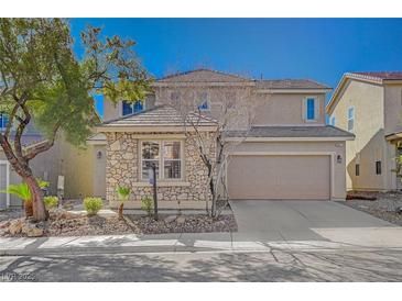 Charming two-story home with stone accents, a two-car garage, and desert landscaping at 8027 Anasazi Ranch Ave, Las Vegas, NV 89131