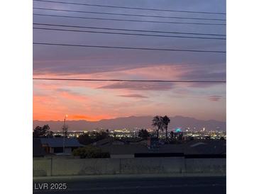 Striking twilight view showcases the cityscape and mountain range in the background at 807 Zinnia Cir, Henderson, NV 89015