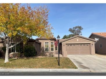 Charming single-story home featuring a well-manicured front yard and a two-car garage at 8212 Cabin Springs Ave, Las Vegas, NV 89131