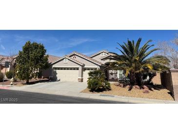 Charming single-story home with a desert landscaped front yard and attached two-car garage at 9204 Gentle Cascade Ave, Las Vegas, NV 89178