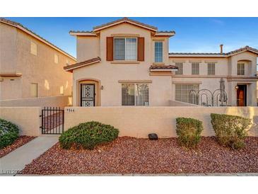 Charming two-story townhome features desert landscaping, a private front yard, and a classic stucco facade at 9564 Belle Fountain Ave, Las Vegas, NV 89123