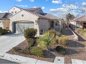 Charming single-story home featuring desert landscaping, a two-car garage, and a tile roof at , Las Vegas, NV 89131