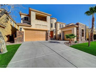 Charming two-story stucco home with a stone accents, a three-car garage, and a well-manicured lawn at 10530 Eagle Nest St, Las Vegas, NV 89141