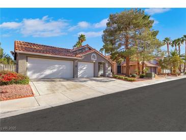 Charming single-story home with a two-car garage and well-manicured landscaping at 1808 Scenic Sunrise Dr, Las Vegas, NV 89117
