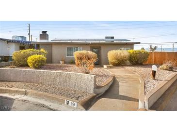 Charming single-story home with a desert landscape, solar panels, and a welcoming walkway at 19 Montana Way, Henderson, NV 89015