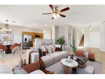 Inviting living room featuring an open layout, tile flooring, and neutral color palette at 2276 Laramine River Dr, Henderson, NV 89052