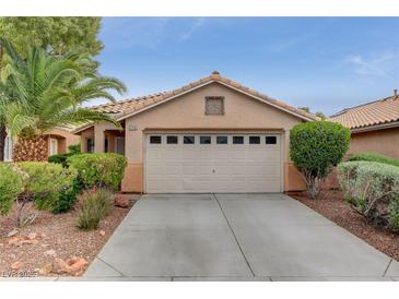 Charming single-story home featuring a tile roof, well-manicured landscaping, and an attached two-car garage at 228 Silver Castle St, Las Vegas, NV 89144