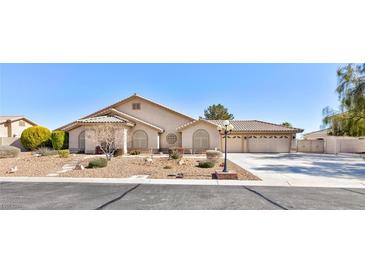 Charming single-story stucco home with desert landscaping and a three-car garage at 4690 Designer Way, Las Vegas, NV 89129