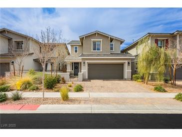 Charming two-story home with a well-manicured front yard and a brick paved driveway at 683 Quasi St, Henderson, NV 89011