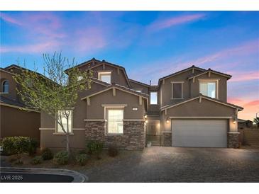 Charming two-story home boasts a stone accent, attached two car garage and a beautifully landscaped front yard at 8895 Dartmouth Grove Ave, Las Vegas, NV 89148