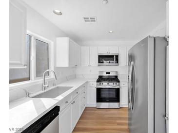 Bright kitchen featuring stainless steel appliances, white cabinets, and ample counter space at 9017 Becoming Ct, Las Vegas, NV 89149
