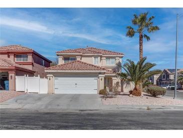 Charming two-story home with a well-maintained front yard and a two-car garage at 9680 Granite Gorge Ct, Las Vegas, NV 89148