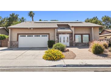 Charming single-story home with well-manicured landscaping and a two-car garage in a residential neighborhood at 2233 Marlboro Dr, Henderson, NV 89014