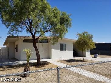 Charming single-story home with a well-maintained lawn, mature trees, and gated entrance at 2705 Howard Dr, Las Vegas, NV 89104