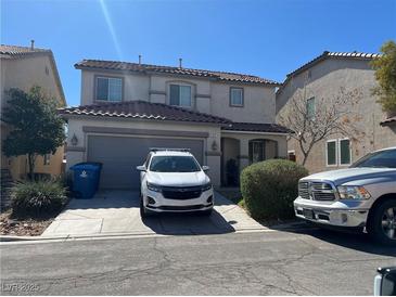 Two-story home with a two-car garage, concrete driveway and low-maintenance landscaping on a sunny day at 311 Bianco Ridge Ave, Las Vegas, NV 89183