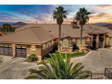 Expansive home featuring a multi-car garage, water feature, desert landscaping, and a tile roof at 402 E Country Club Dr, Henderson, NV 89015