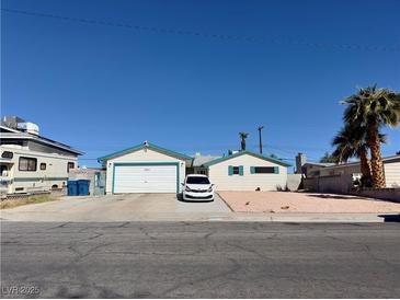 Charming single-story home featuring a two-car garage, white siding, and a well-maintained front yard at 4324 Hanford Ave, Las Vegas, NV 89107