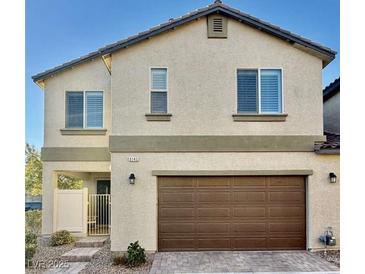 Two-story home with a neutral color palette, a two-car garage, and a well-maintained front yard at 6145 Scarlet Leaf St, Las Vegas, NV 89148