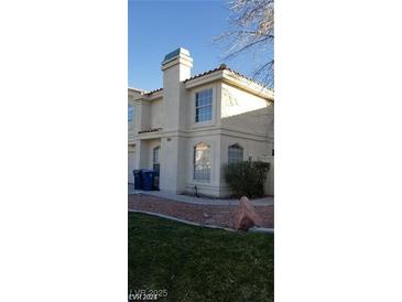 Charming two-story home with landscaped yard, windows, and front yard at 7963 Laurena Ave, Las Vegas, NV 89147