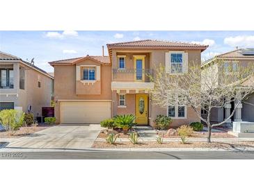 Charming two-story home with a yellow front door and a balcony over the entry at 9413 Ironsend St, Las Vegas, NV 89143