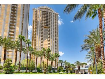 Stunning high-rise towers surrounded by lush palm trees against a clear blue sky at 145 E Harmon Ave # 2008, Las Vegas, NV 89109