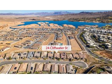 Spectacular aerial view of a lakefront community with modern homes and scenic mountain backdrop at 24 Cliffwater St, Henderson, NV 89011