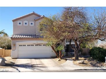 Charming two-story home with a tile roof, three upper windows and a large two car garage and landscaped yard at 281 Deerleap Cir, Henderson, NV 89052