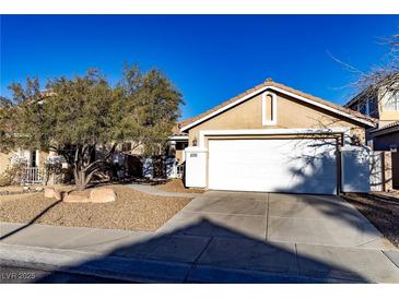 Charming single-story home features a two-car garage, desert landscaping, and a cozy, inviting entrance at 3208 Paragon Pointe St, Las Vegas, NV 89129