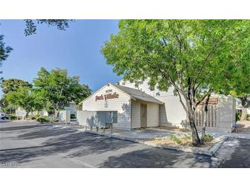 Park Village community building with mature shade tree and parking area at 4770 Topaz St # 31, Las Vegas, NV 89121