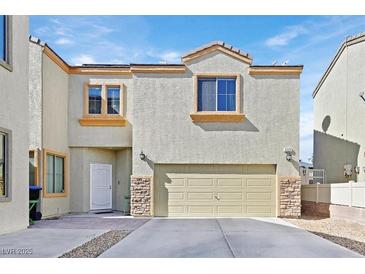 Two-story home with a two-car garage and stucco exterior, accented by stone veneer on the garage's corners at 6329 Aloha Sue St, North Las Vegas, NV 89031