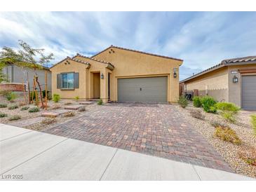 Charming single-story home boasts a brick driveway and well-maintained landscaping at 697 Sunray Park St, Henderson, NV 89011