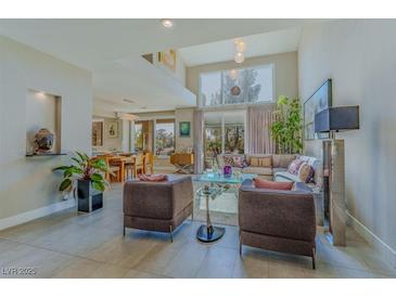 Bright living room features large windows, high ceilings, and contemporary furnishings at 7999 Pinnacle Peak Ave, Las Vegas, NV 89113