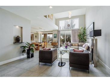 Bright living room featuring neutral colors, recessed lighting, and large windows that provide plenty of natural light at 7999 Pinnacle Peak Ave, Las Vegas, NV 89113