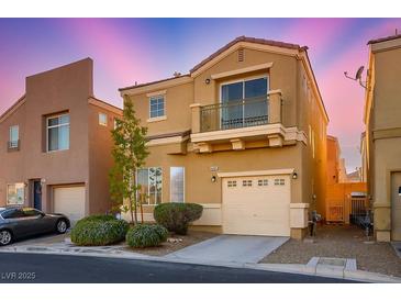 Inviting two-story home with charming balcony, attached garage, and manicured landscaping at 9489 Liquid Loco St, Las Vegas, NV 89178