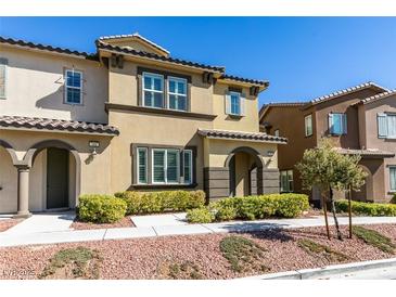 Charming townhome featuring desert landscaping, arched entryway and neutral color palette at 11396 Ogden Mills Dr # 101, Las Vegas, NV 89135