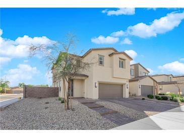 Charming two-story home featuring a two-car garage, landscaped front yard and brick steps at 2865 Victorian Rd, North Las Vegas, NV 89086