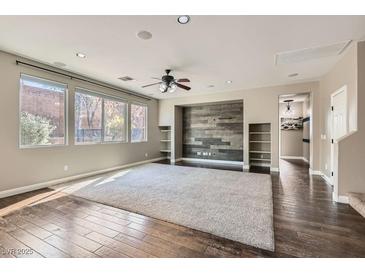 Spacious living room boasts hardwood floors, large windows, neutral carpet, and a sleek accent wall at 336 S Milan St, Henderson, NV 89015