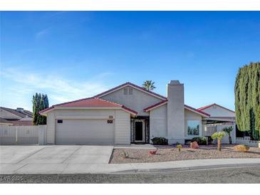 Charming single-story home featuring a desert landscaped yard, red tile roof, and attached two-car garage at 602 Paloma Dr, Boulder City, NV 89005