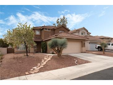 Charming two-story home features a well-manicured front yard with mature trees and a stone pathway to the front door at 7837 Silver Plateau Ave, Las Vegas, NV 89128