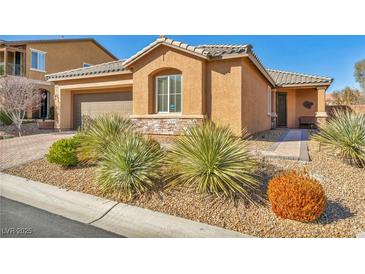 Charming single-story home featuring desert landscaping, a tiled roof, and an inviting front entrance at 9076 Bridal Creek Ave, Las Vegas, NV 89178