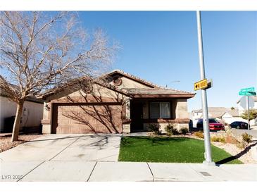 Charming single-story home featuring a well-manicured lawn and a two-car garage at 9424 Fox Forest Ave, Las Vegas, NV 89129